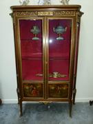 A Louis 16 style two doors cabinet with vernis-matin paintings and mounted bronzes.