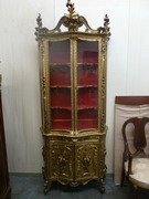 a gilded Italian display cabinet