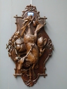 A highly carved wooden hunting panel.
