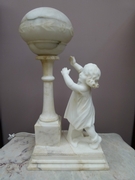 A alabaster lamp with a little girl.