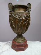 A bronze vase on red marble base by Barbiedienne.