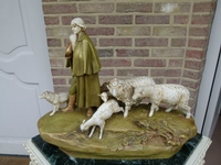 A Royal Dux groupe of a shepherd with his dog and sheep.