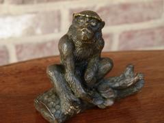 Signed with a V.1902 Miniature bronze sculpture of a monkey