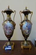 A paire Sevrés vases with romantic scenes.