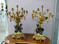 A large pair of gilded and patinated  bronze candelabra whit putto,s