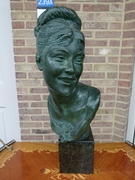 A large buste of a lady by Jef lambeaux.
