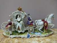 A Volkstedt porcelain carriage.
