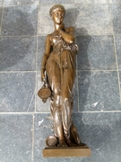 A bronze sculpture of a lady with a lamp by Dumaige H 71cm.